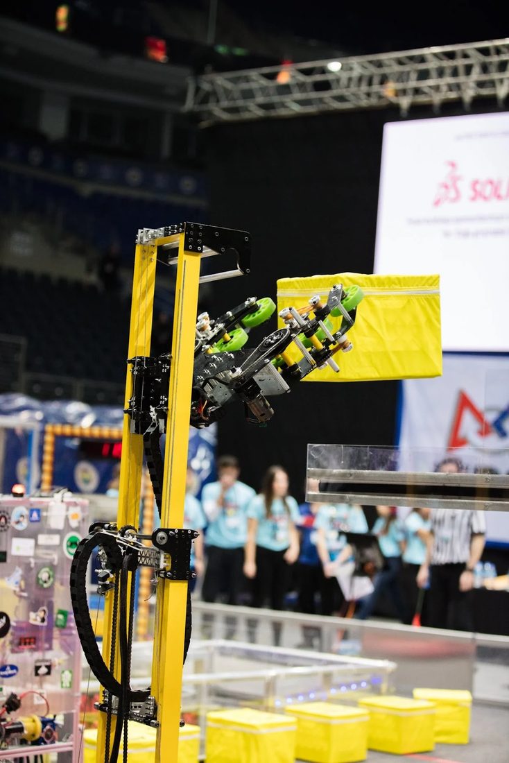 Team Integra 3646 FRC robot lifting a game piece during a FIRST competition match