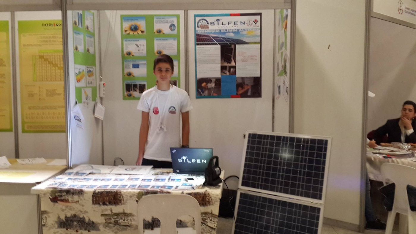 Young Onat Cakici presenting his portable solar generator at a science fair